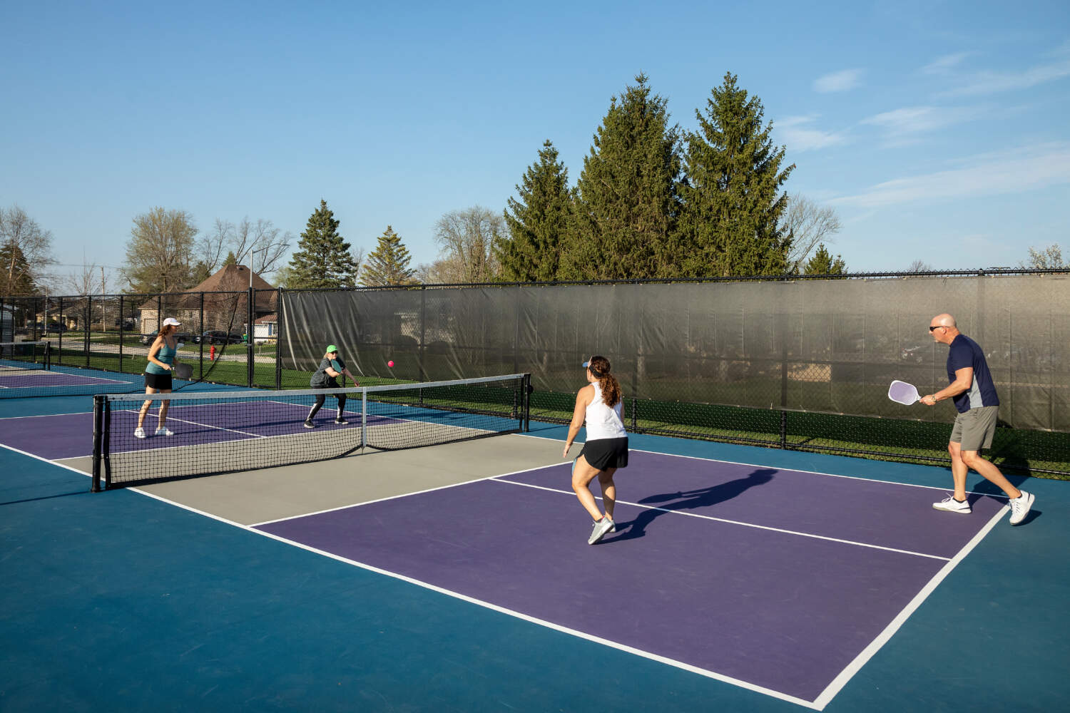 Female Pickleball Player Returning Ball